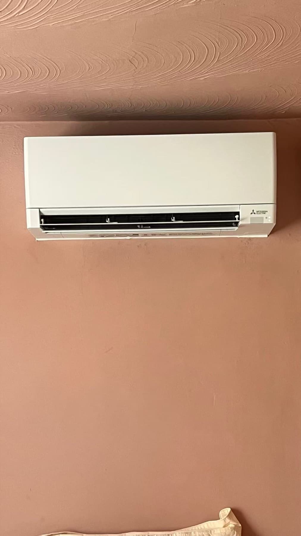 Mitsubishi indoor mini-split mounted above a finished wall